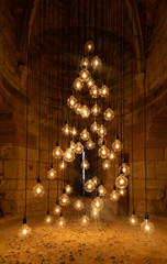 Bulbs hanging with wire forming christmas tree