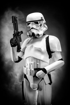 SAN BENEDETTO DEL TRONTO, ITALY. NOVEMBER 11, 2017. Studio portrait  of stormtrooper costume replica, with blaster E-11 gun. He is a fictional character of Star Wars saga. Black background with smoke 
