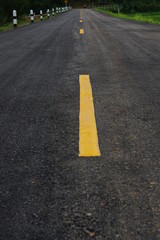 asphalt road with yellow lines