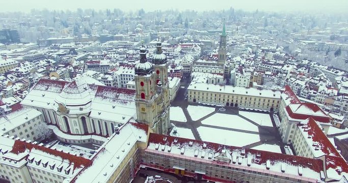 St. Gallen, Switzerland - Amazing drone footage of the historical city of Saint Gallen in north Switzerland, with the old town and churches covered in snow.