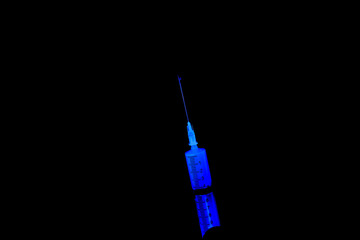 Man is holding syringe injection. Medical treatment of a low quality. Black gloves. Syringe with...