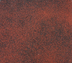 The typical racing track is covered by the old rubber in the stadium