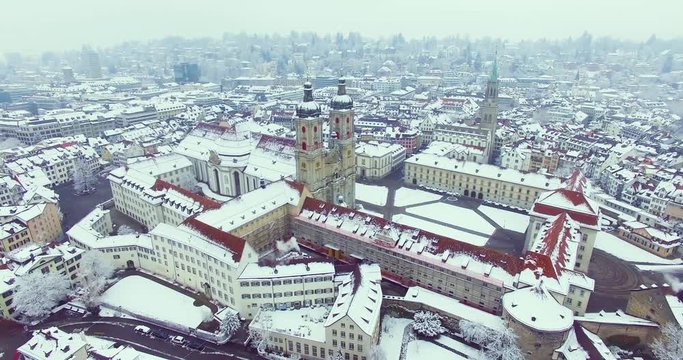 St. Gallen, Switzerland - Amazing drone footage of the historical city of Saint Gallen in north Switzerland, with the old town and churches covered in snow.