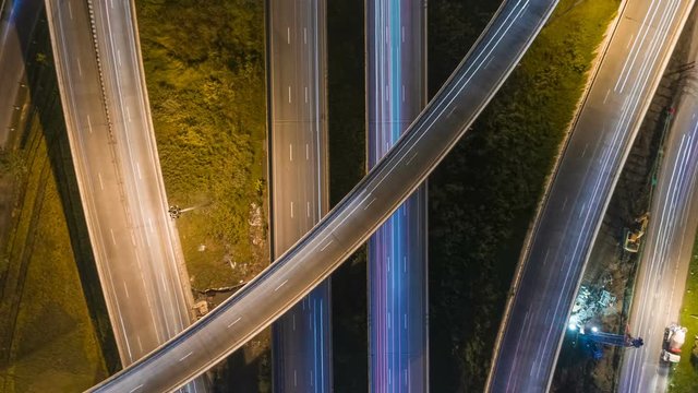aerial shot view of traffic on freeway interchange at night. 4K UHD timelapse background