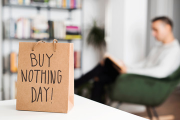 text buy nothing day in a shopping bag. - obrazy, fototapety, plakaty