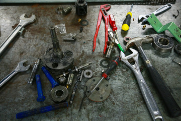Tools on table in workshop or the garage for repair the machine with spare part of the machine. Technician work on the workshop and used special tools for fix and service the machine.