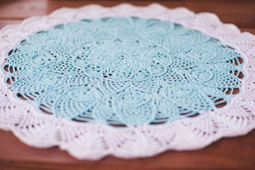knitted napkin of these threads brown and blue. the view from the top. all this on a wooden surface