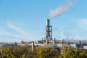 Obraz premium oil or gas refinery smoking chimney 
