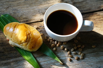 Breakfast with coffee and croissants on wooden vintage table