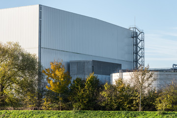Fototapeta na wymiar Big industrial warehouse in nature