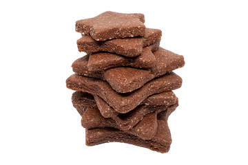 Delicious homemade chocolate and sugar cookies in the shape of stars of different sizes, piled up on top of each other, isolated on a white background. Christmas baking for the whole family