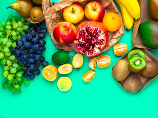 Naklejka na ściany i meble Fruits and vegetables rich in antioxidants, vitamin and fiber on trendy mint green background. Flat lay style. Super food