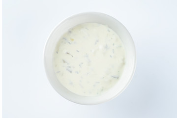 cream sauce with pickles in a bowl on a light background, mayonnaise