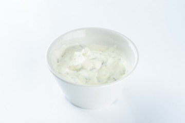 cream sauce with pickles in a bowl on a light background, mayonnaise