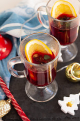 mulled wine of red wine and spices and orange and Christmas decorations