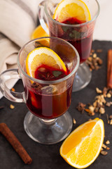 mulled wine of red wine and spices and orange on the table