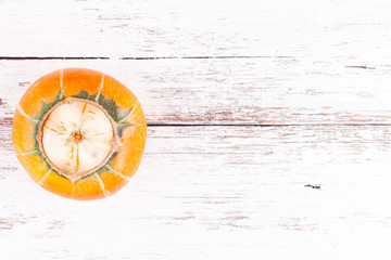 Ugly pumpkin with mutation other pumpkin inside on white wooden table background with copy space. Concept of zero waste production in food. Top view.