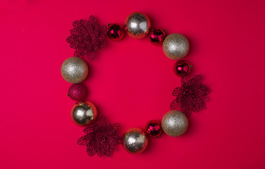 Red and gold Christmas balls on red background, top view , copy space, flat lay