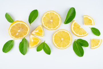 Slice lemon and leaves on white background