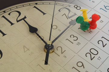 Clock and calendar page with push pins. Time, planning and appointment concept