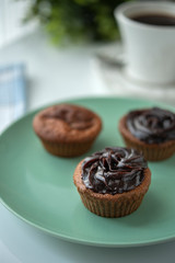 Chocolate muffin with coffee next to the window