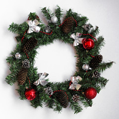 Obraz na płótnie Canvas Christmas wreath with red and silver balls
