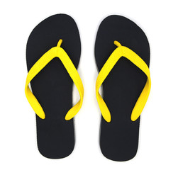 Tropical summer concept. black sandals, yellow straps from the top view on white blackground.