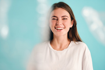 Beautiful cheerful girl happily looking in camera over colorful background isolated