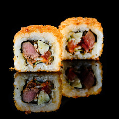 beautiful sushi rolls on a black background with reflection for the menu