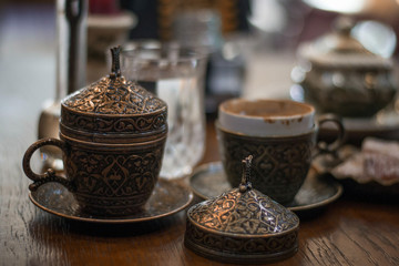 Vintage cups of turkish coffee and glass of water