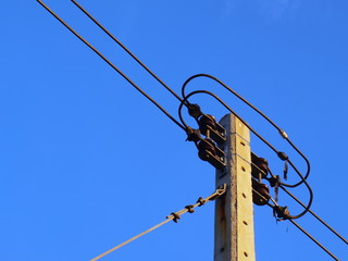 Low-voltage cable on the pole With a guide cable to hold the pole on the background of the bright...