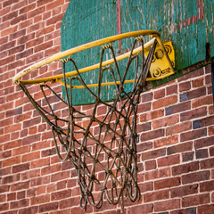 Old rusty basketball cart on a brick wall