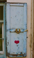 An old blue door with painted heart