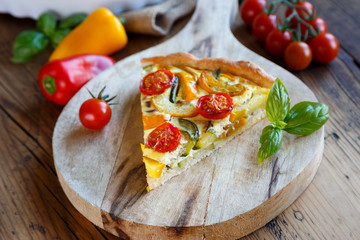 Fototapeta na wymiar Quiche with tomatoes, spinach and feta cheese