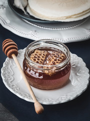 Christmas table with decoration, wafers, honey and garlic bulbs.