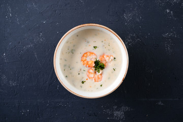 Cauliflower cream soup with skewered prawns