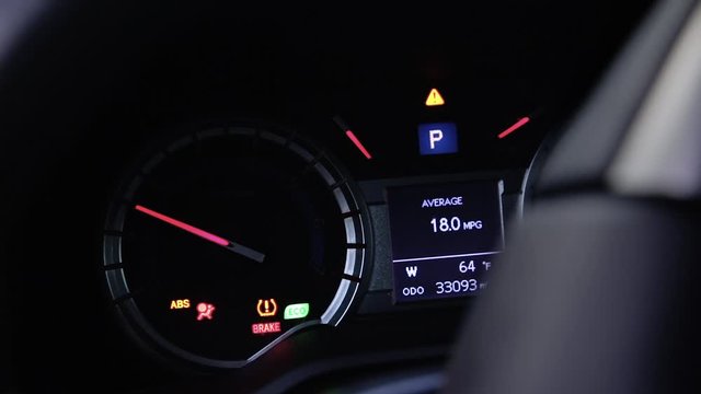 Modern car dashboard gauges lighting up when car is started.