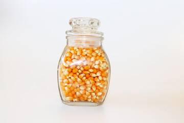  Corn kernels in a jar on a white background