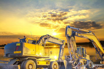 excavator on construction site © Thongtu