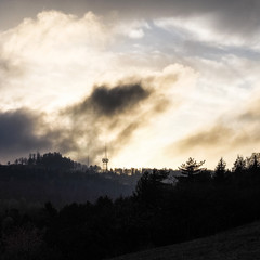 Dark clouds on a hill with mobile pole device