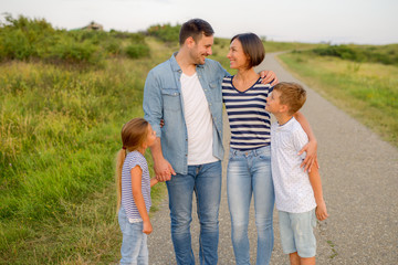 Shot of a family of four enjoying a sunny day in the nature