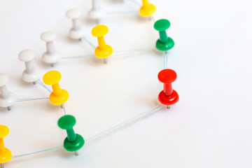 Leader, leadership concept. Red pin with other in connection. Сommunication chain, team structure.