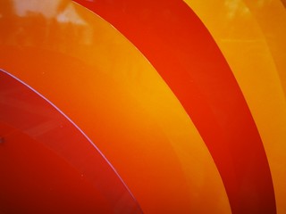Bright wavy pattern with 3d effect. Photo of plastic panels. Dynamic style. Orange- Red background.Colorful wavy background.