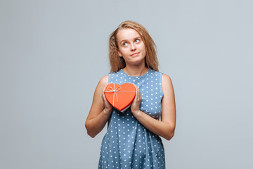 Girl holding heart gift box