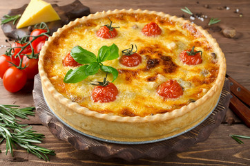 Freshly baked homemade pie quiche Lorraine on a wooden table