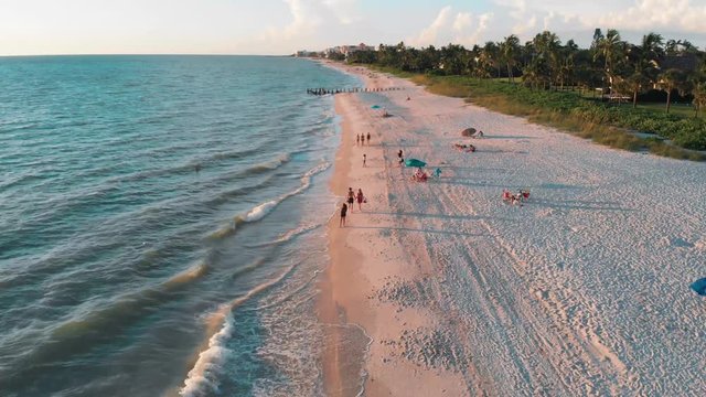 Drone shot of people in the beach in Naples Florida