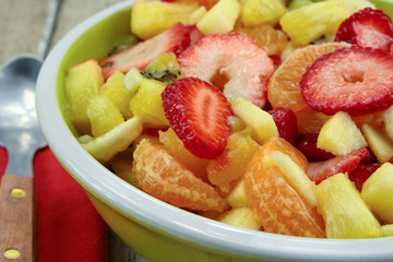 plate of fresh fruit salad on a wooden table