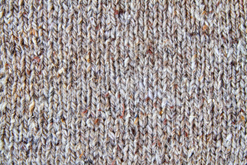 Brown or gray knitted textured background. Closeup