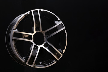 Obraz premium car cast aluminum alloy wheels, black silver with polished front, very beautiful and modern, fashion. Close-up on dark background, elements, spokes.