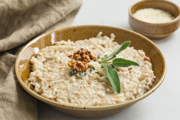 Risotto with gorgonzola cheese, parmesan, walnuts, sage and arborio rice. Homemade. White background